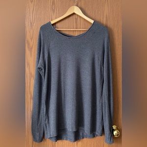 Flowy light sweater with thumb holes and cross cross back.